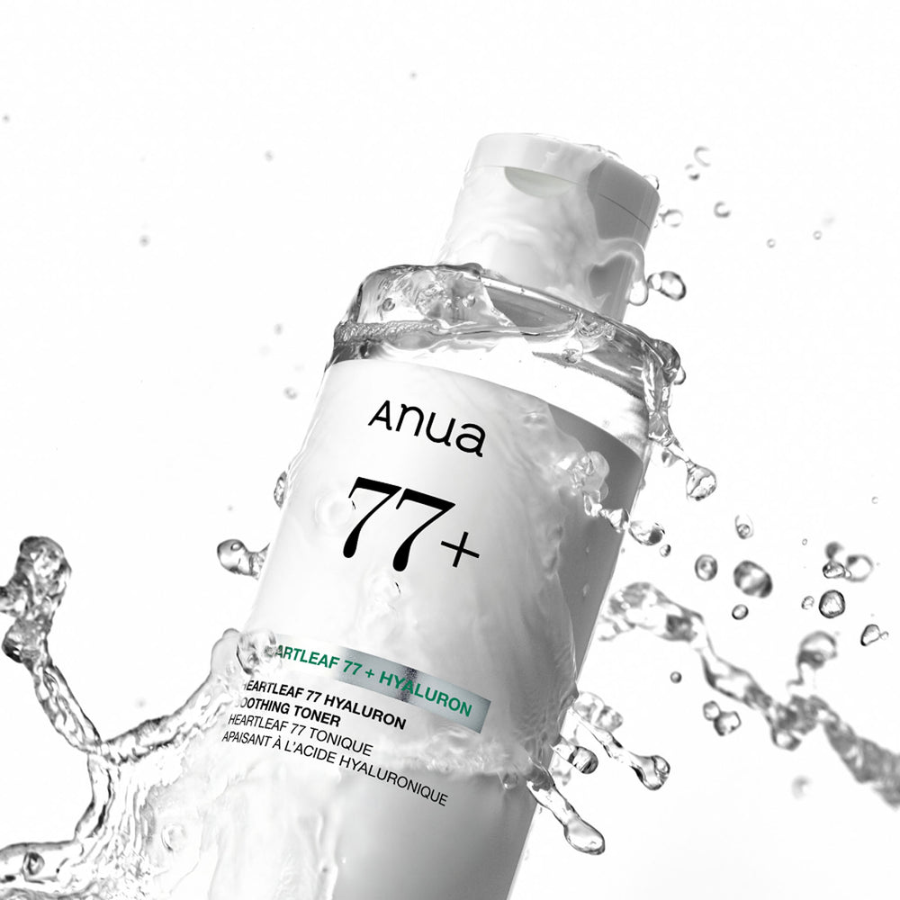 Anua Heartleaf 77 Soothing Toner bottle tilted diagonally with splashing water against a white background.